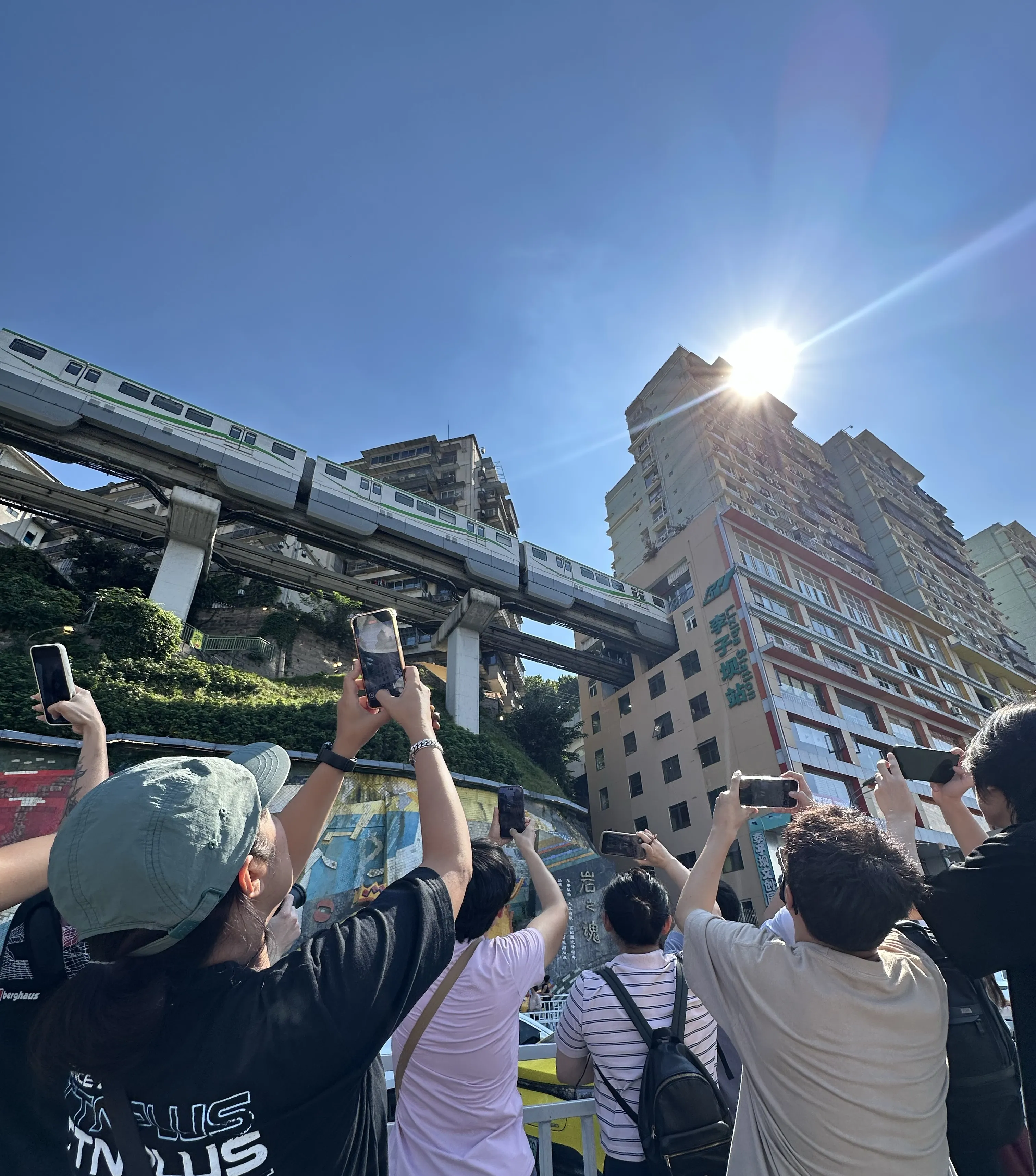 Liziba monorail train passing through apartment building - engineering marvel in Chongqing