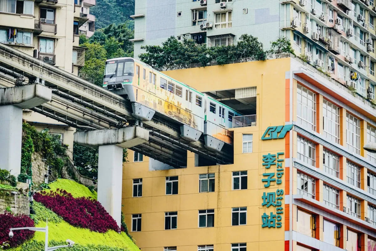 Liziba Monorail Station - Train passing through residential building in Chongqing